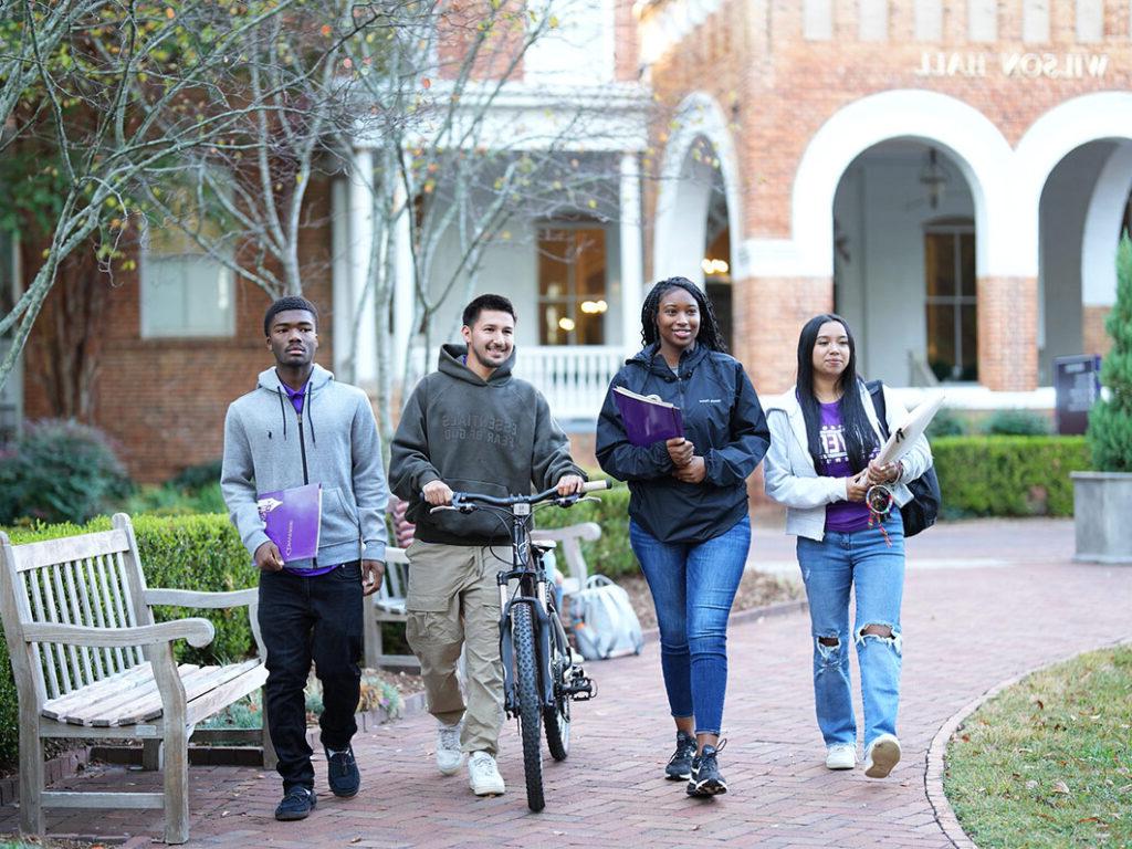 Smiling Converse students walk on campus